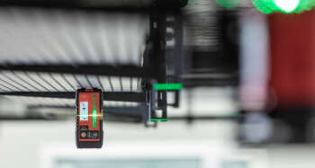 The Leica RGR300-D digital receiver for line lasers in use on a construction site, demonstrating its functionality and ease of use.